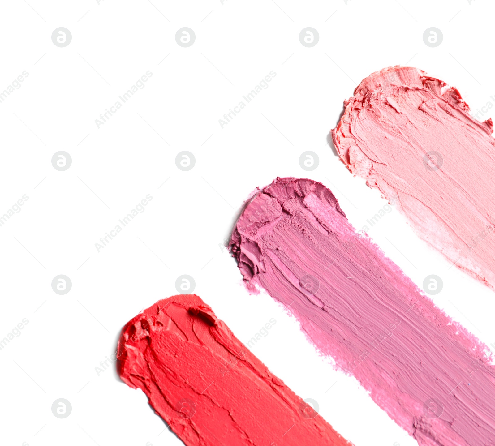 Photo of Strokes of lipstick on white background, top view