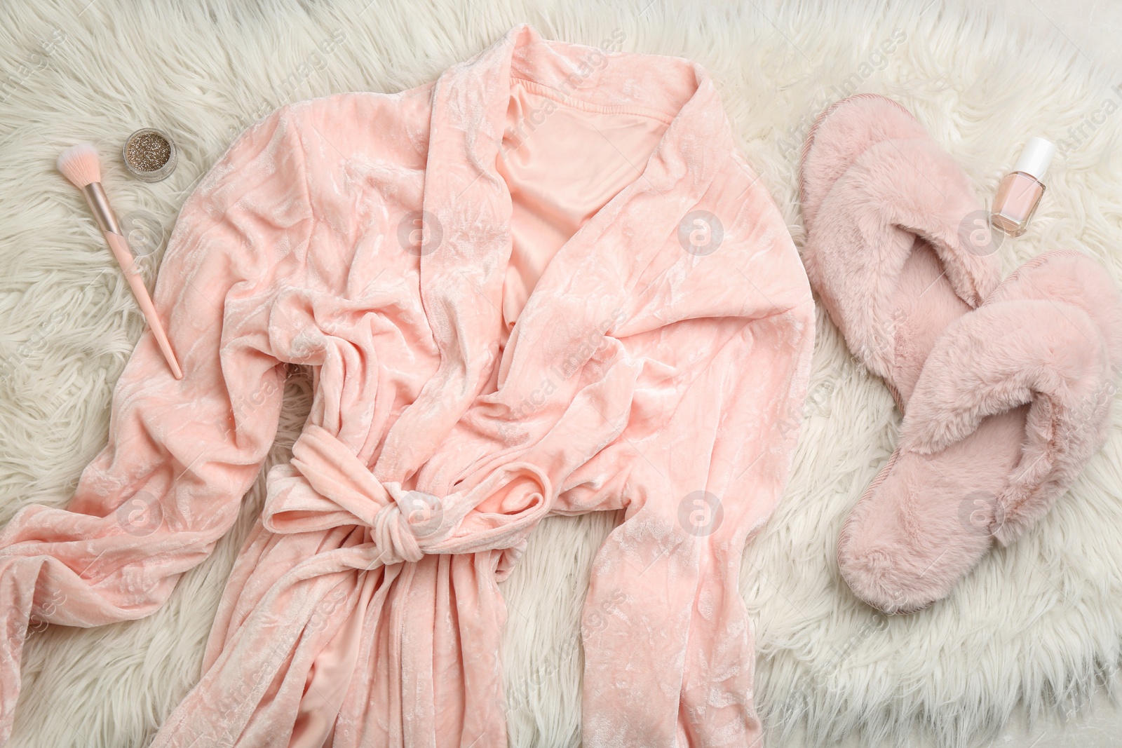 Photo of Flat lay composition with fluffy slippers and bath robe on fuzzy carpet. Comfortable home outfit