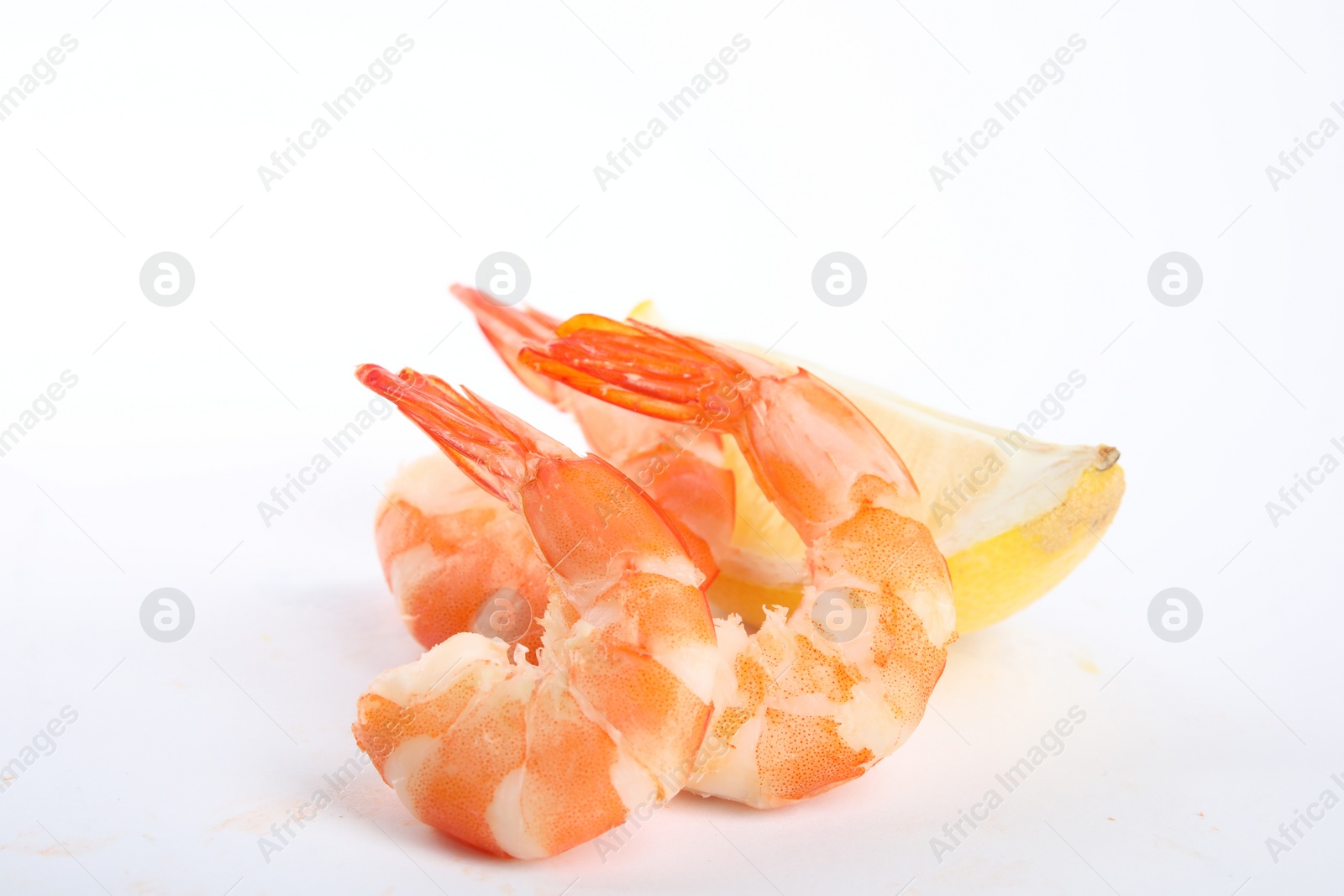 Photo of Delicious cooked shrimps and lemon isolated on white
