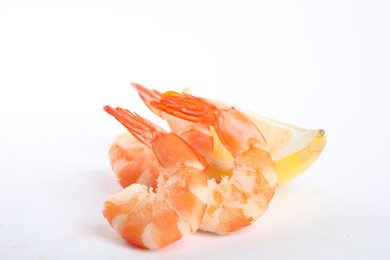 Photo of Delicious cooked shrimps and lemon isolated on white