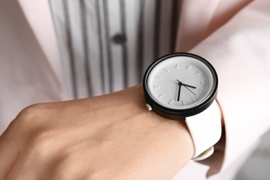 Photo of Businesswoman with stylish wrist watch, closeup. Time management