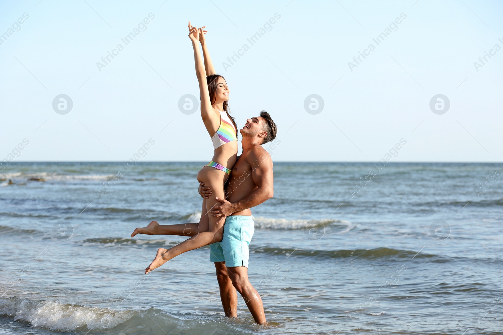 Photo of Happy young couple having fun at beach on sunny day