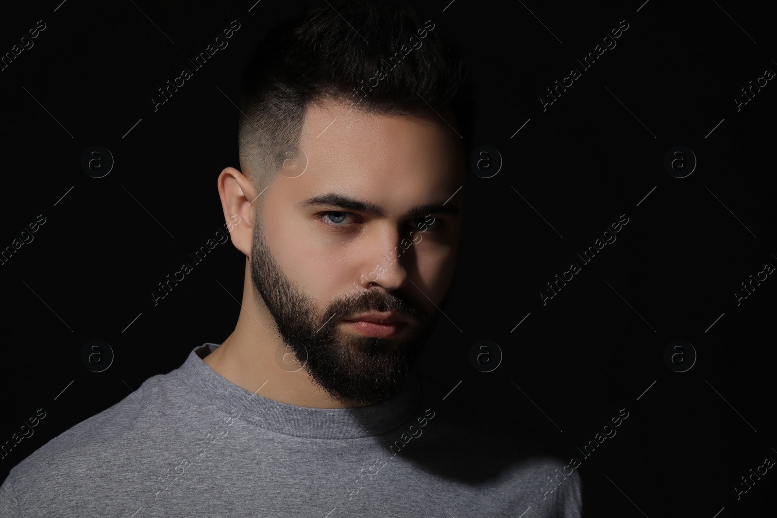 Photo of Evil eye. Man with scary eyes on black background