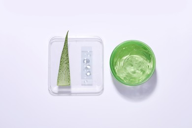 Photo of Organic cosmetic product, natural ingredient and laboratory glassware on white background, top view