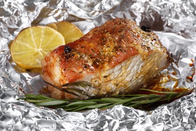 Tasty pork, rosemary and lemon slices baked in foil, closeup