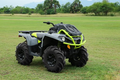 Photo of Modern quad bike on green grass outdoors