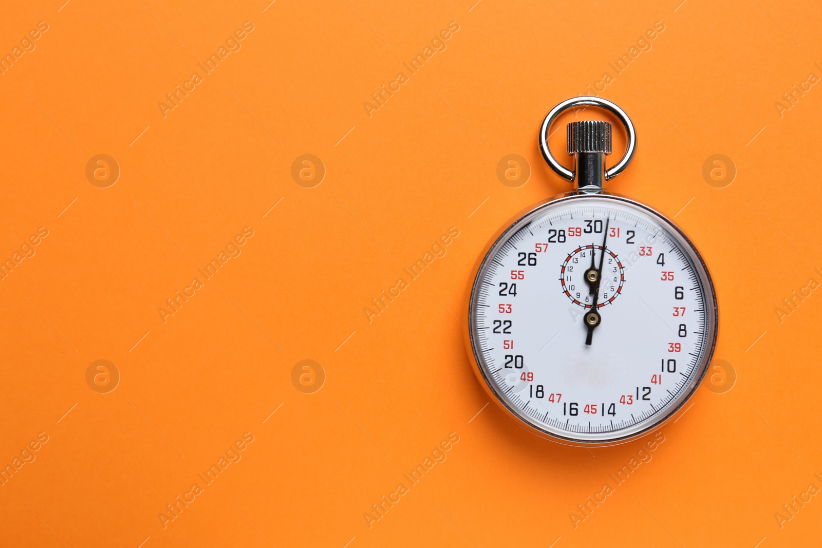 Photo of Vintage timer on orange background, top view. Space for text