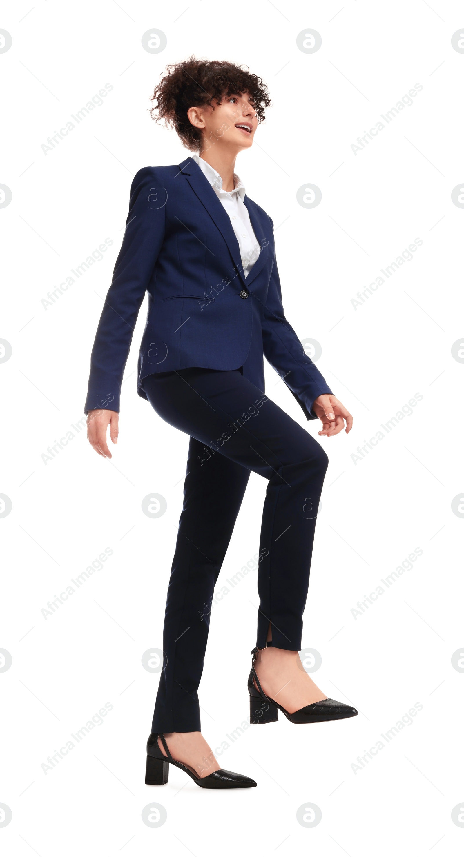 Photo of Beautiful businesswoman in suit walking on white background, low angle view