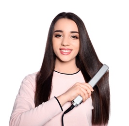 Happy woman using hair iron on white background