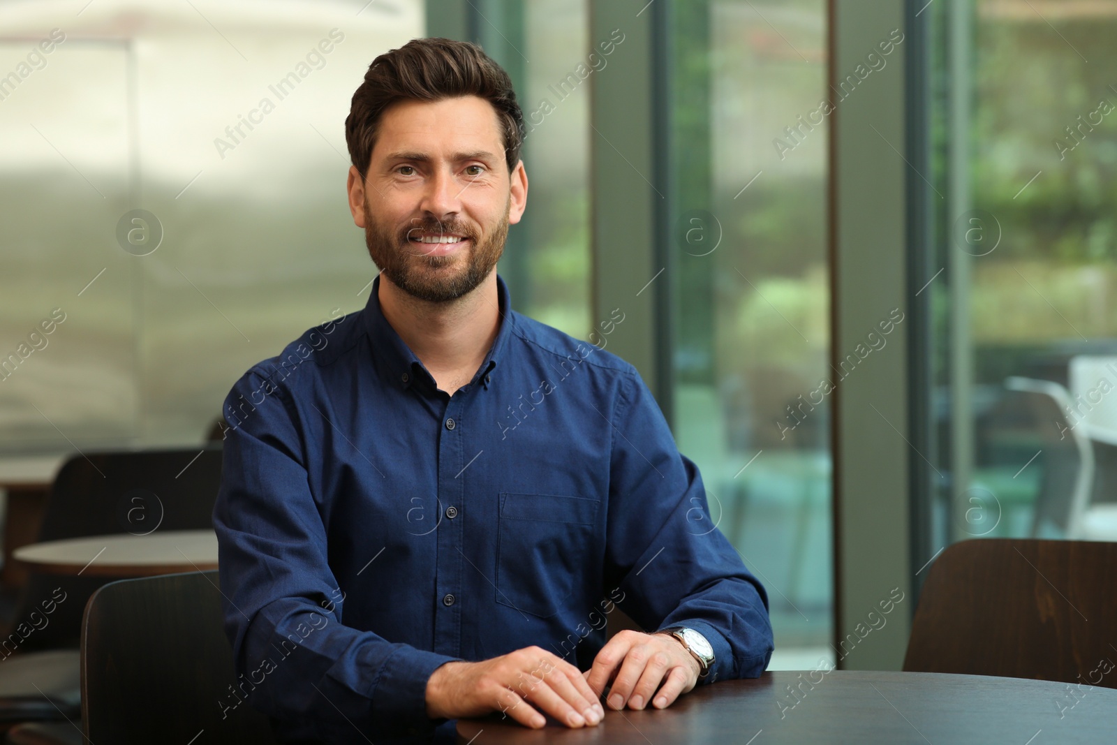 Photo of Portrait of handsome stylish man in cafe