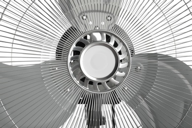 Photo of Electric fan on white background, closeup. Summer heat