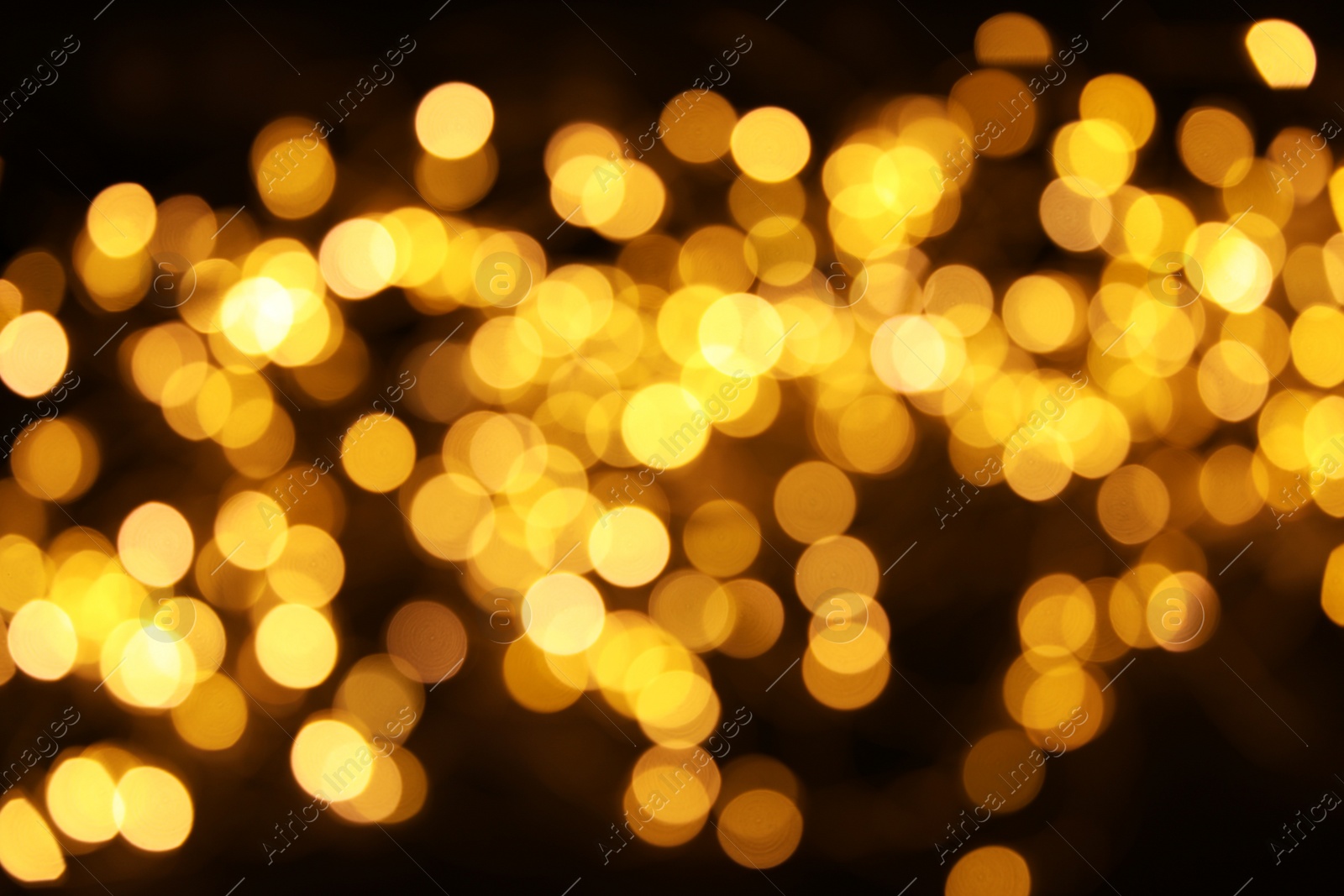 Photo of Gold glitter with bokeh effect on dark background