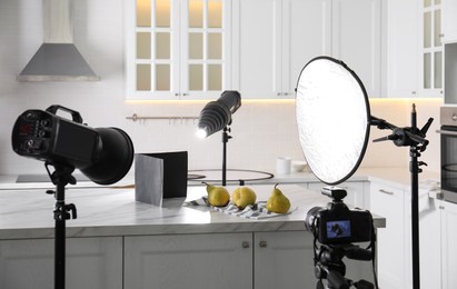 Professional equipment and many pears on table in kitchen. Food photo