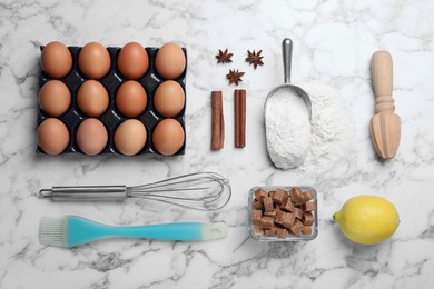 Photo of Cooking utensils and ingredients on white marble table, flat lay