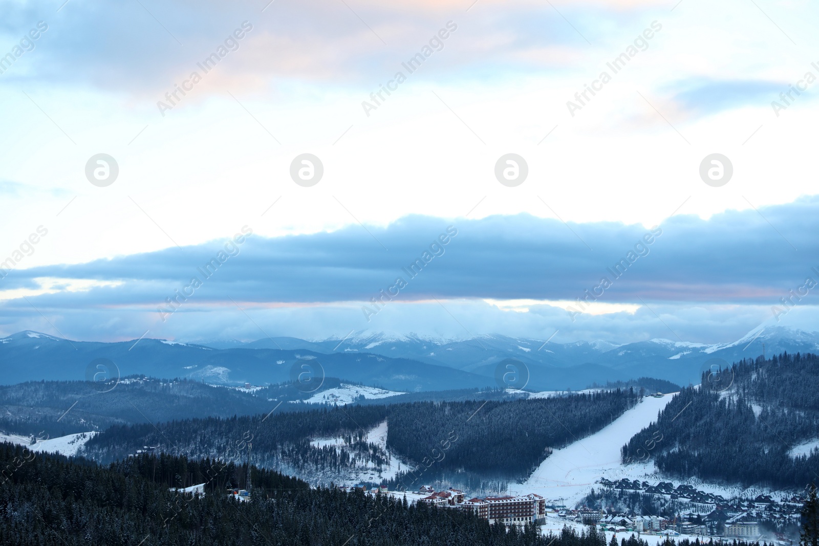 Photo of Beautiful mountain landscape with forest and ski resort in winter