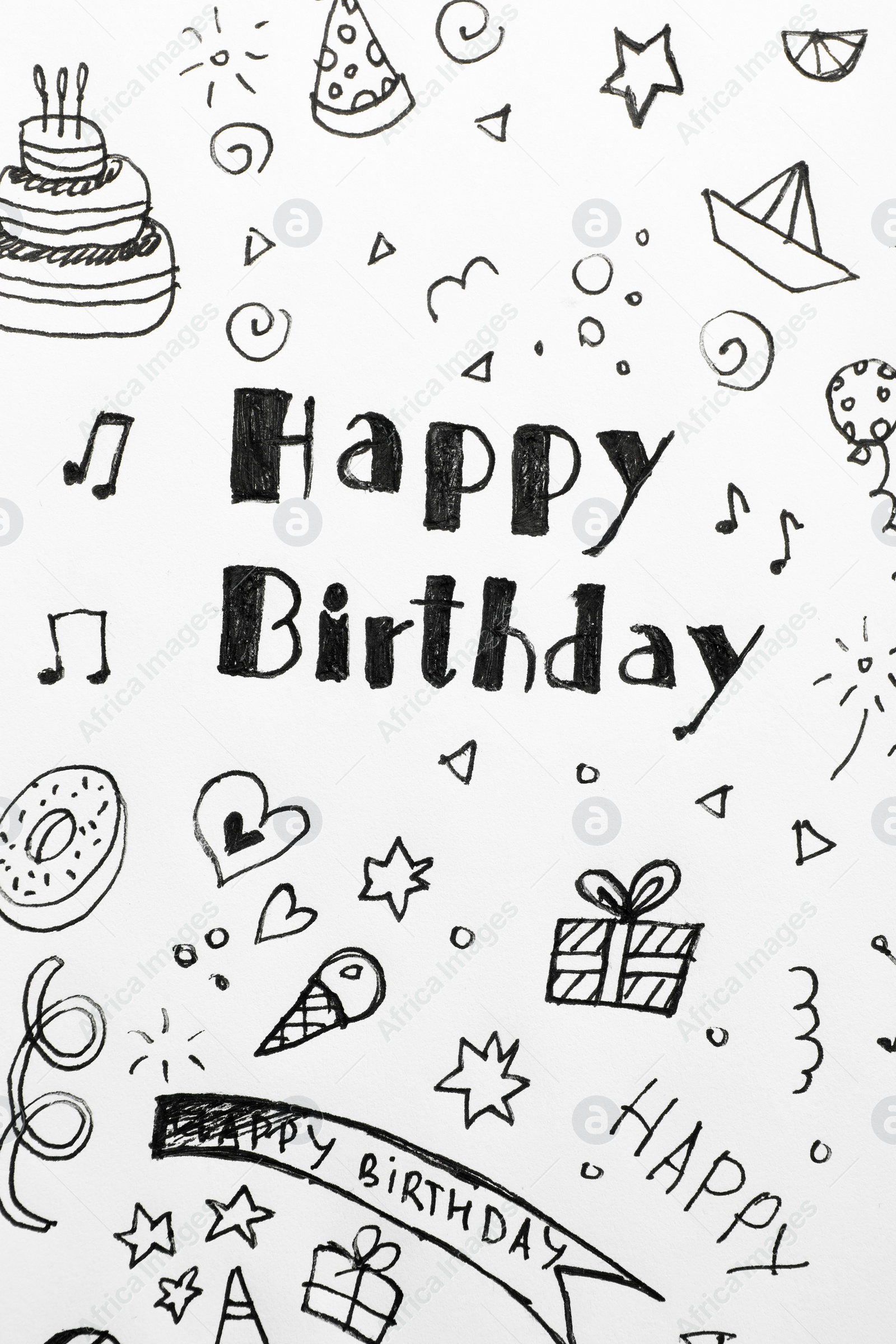 Photo of Words HAPPY BIRTHDAY and funny little pictures on white paper, top view