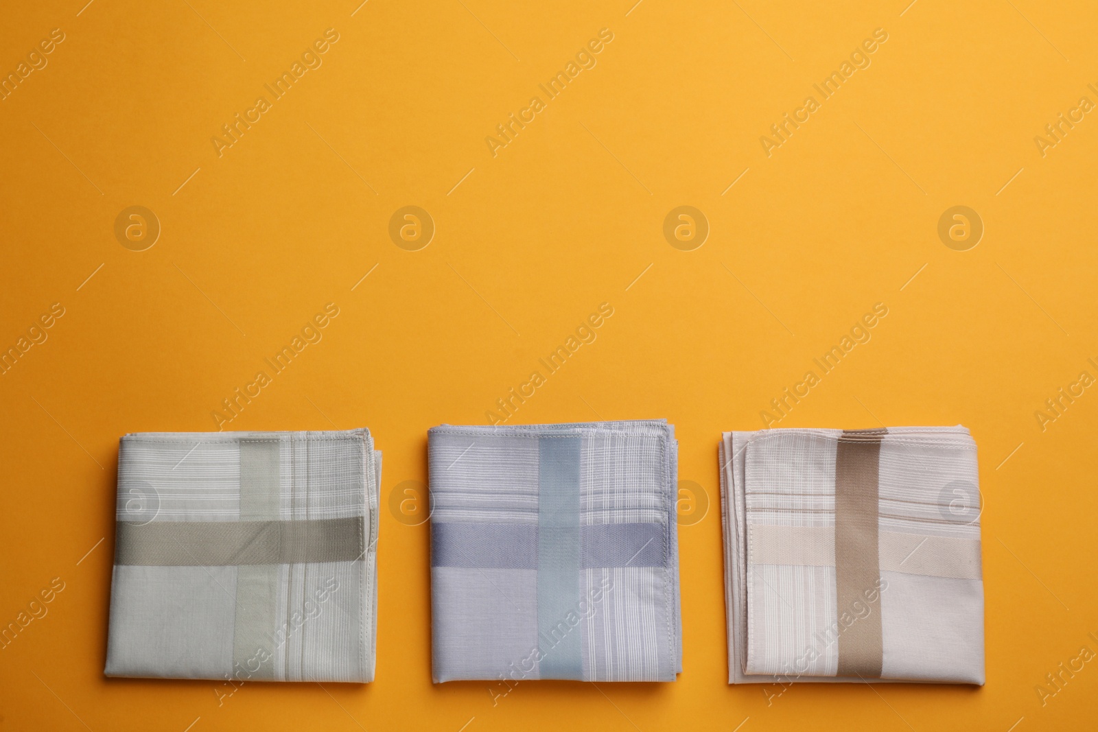 Photo of Stylish handkerchiefs on yellow background, flat lay. Space for text