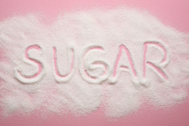 Composition with word SUGAR on pink background, top view