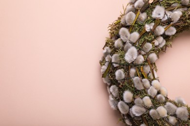 Photo of Wreath made of beautiful willow flowers on beige background, top view. Space for text