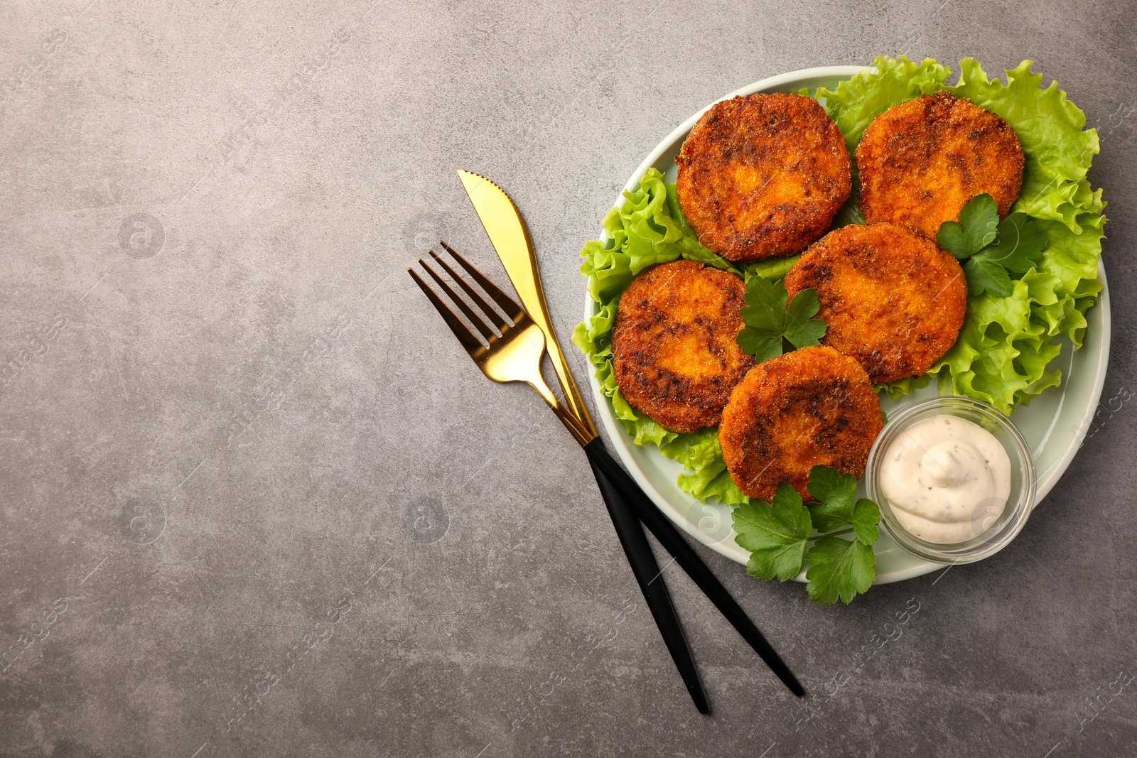 Photo of Tasty vegan cutlets served with sauce on light grey table, flat lay. Space for text