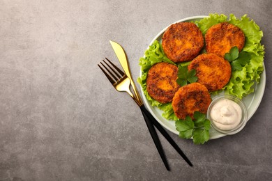 Tasty vegan cutlets served with sauce on light grey table, flat lay. Space for text