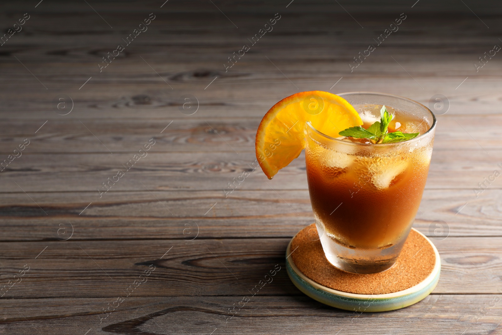 Photo of Tasty refreshing drink with coffee and orange juice on wooden table, space for text