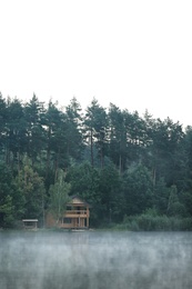 Beautiful landscape with forest and house near lake. Summer camp location
