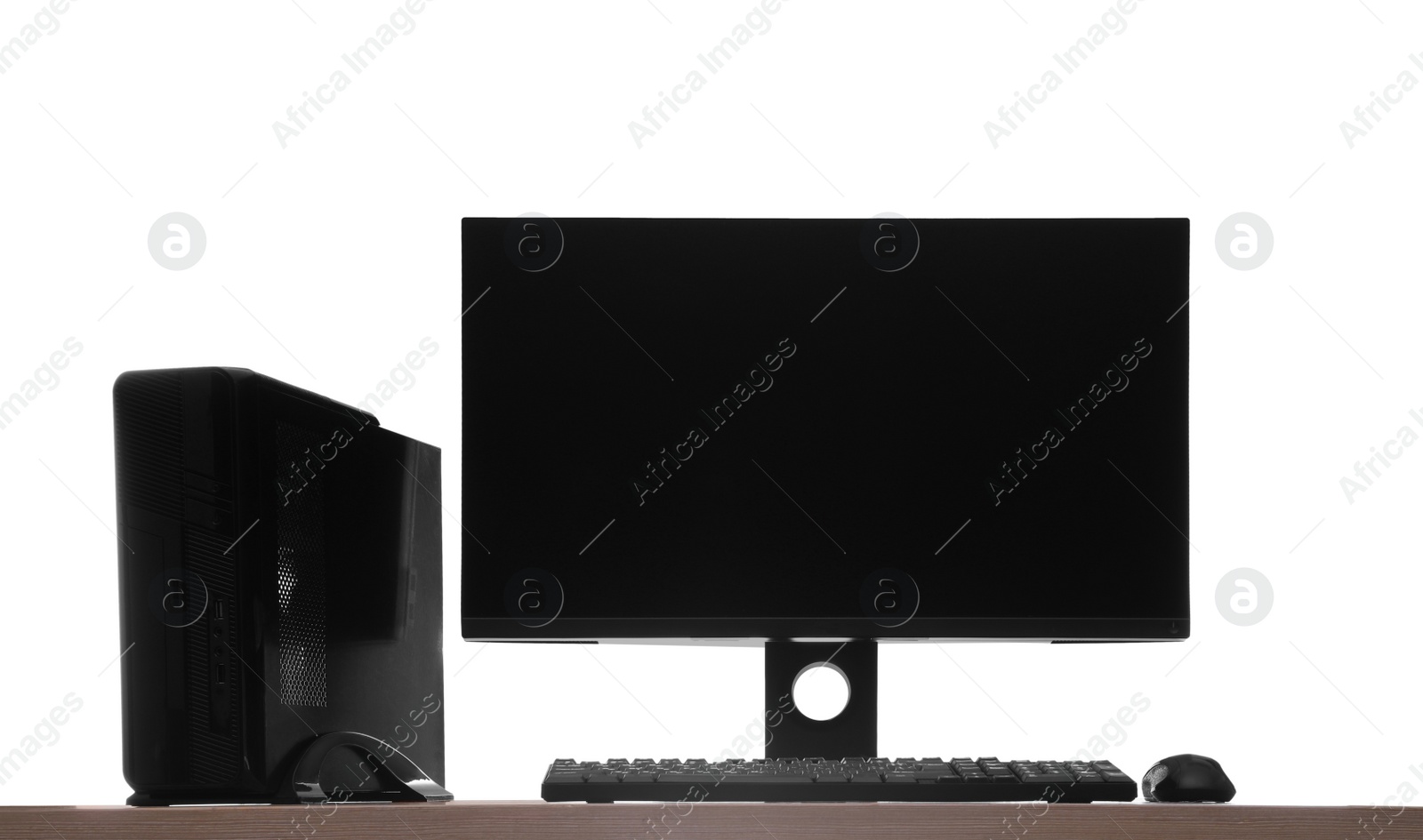 Photo of Modern computer with blank monitor screen and peripherals on wooden table against white background