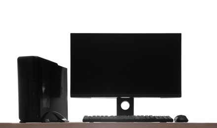 Modern computer with blank monitor screen and peripherals on wooden table against white background