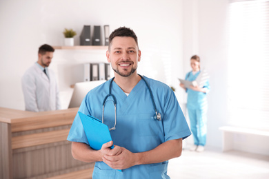 Portrait of male doctor in modern clinic