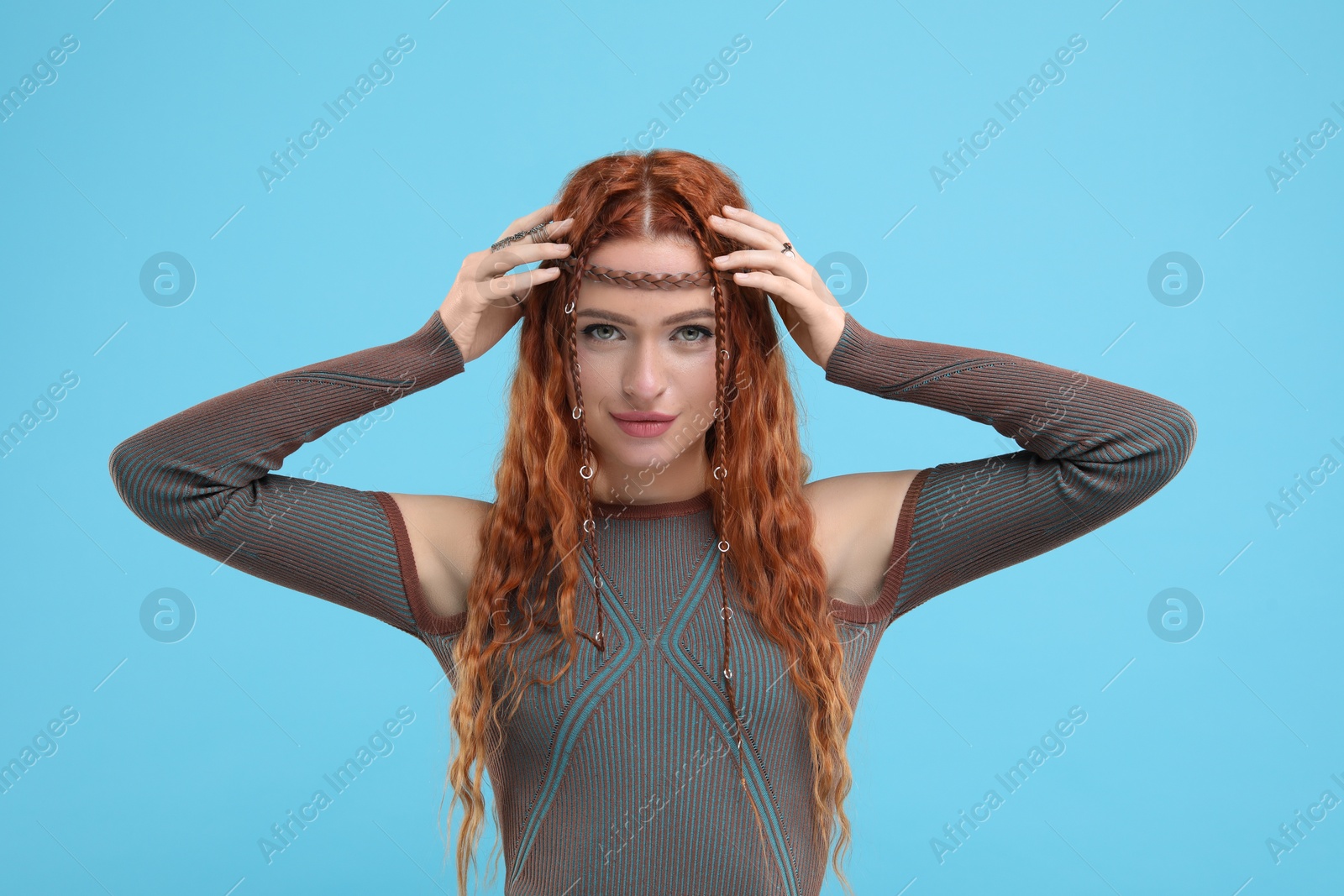 Photo of Beautiful young hippie woman on light blue background