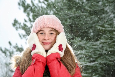 Portrait of teenage girl in winter snowy forest