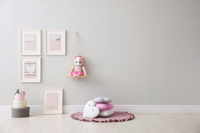 Photo of Stylish room interior with beautiful pictures and toys