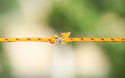 Photo of Frayed rope at breaking point against blurred background