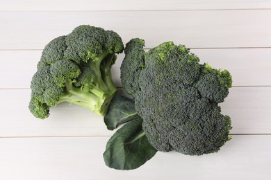 Fresh raw broccoli on white wooden table, top view