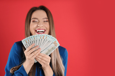 Photo of Young woman with money on crimson background. Space for text