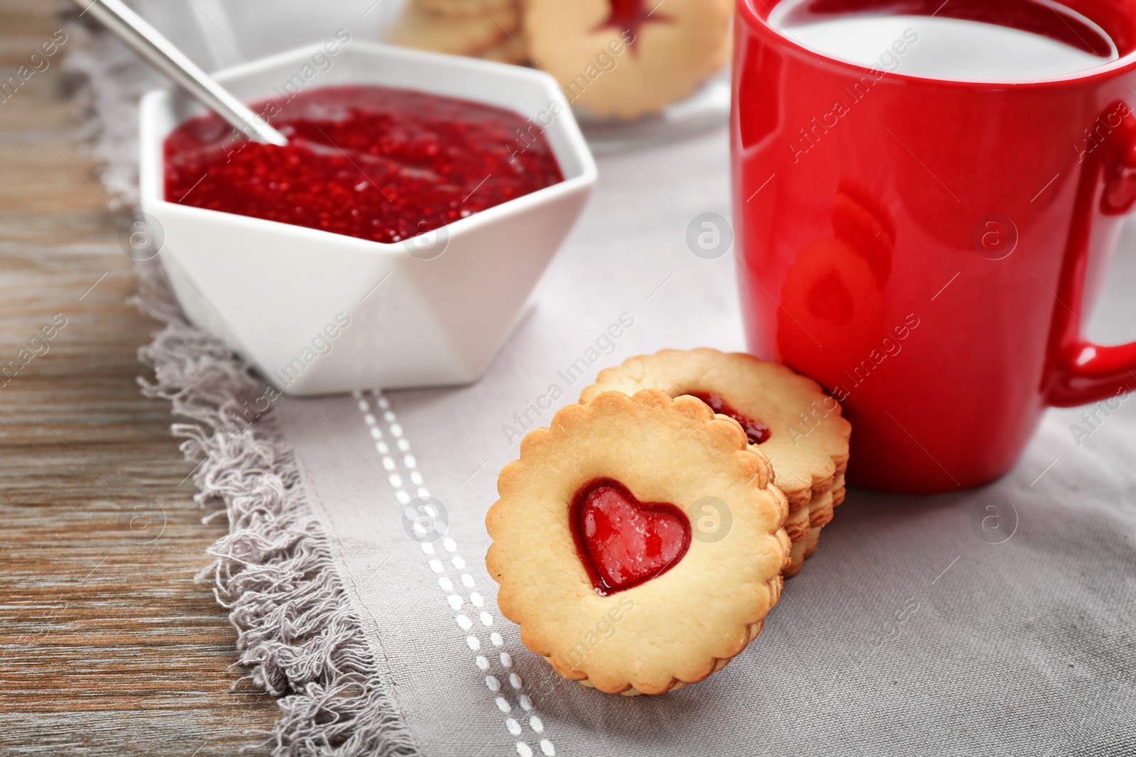 Photo of Traditional Christmas Linzer cookies with sweet jam on table