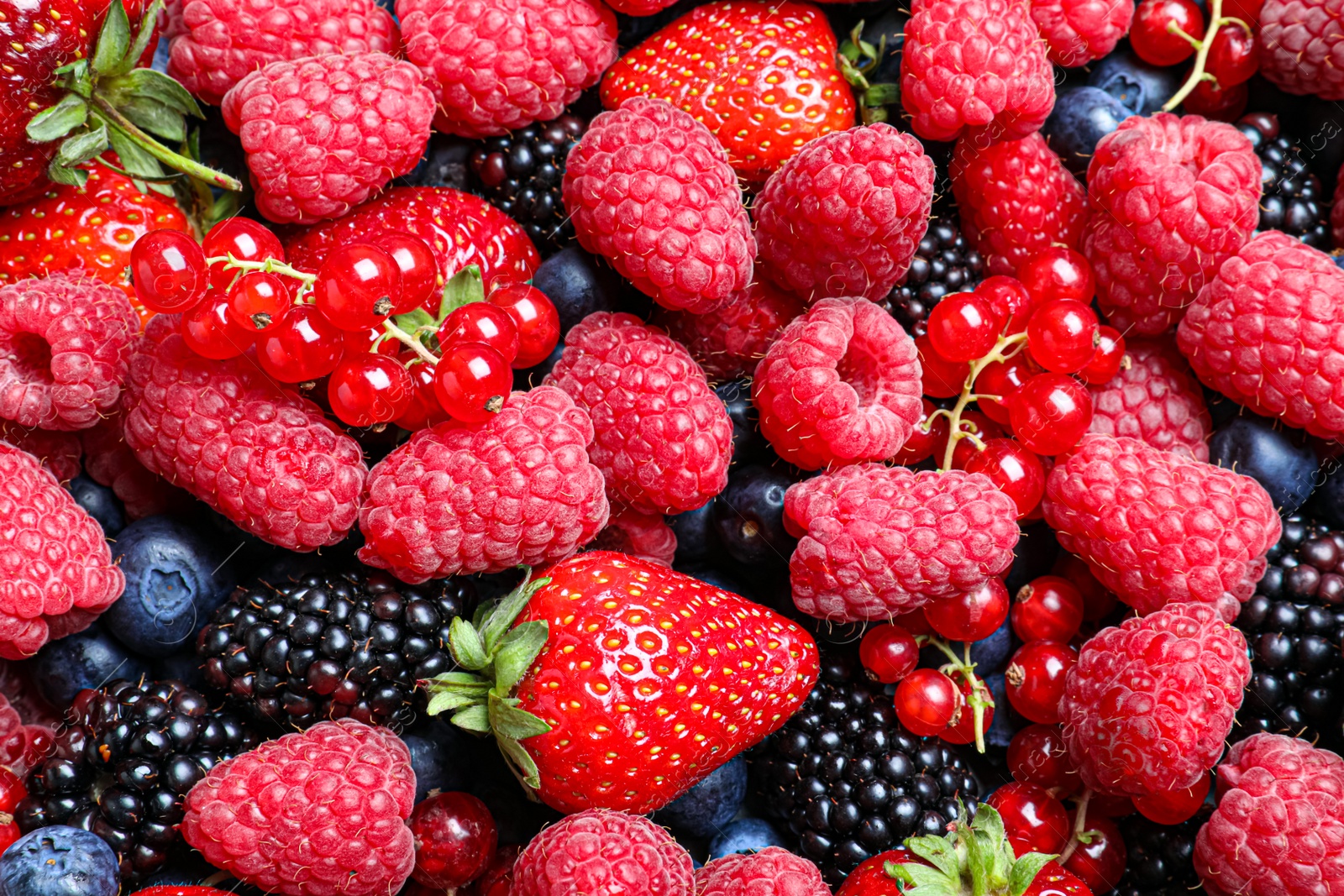 Photo of Mix of different ripe tasty berries as background, top view