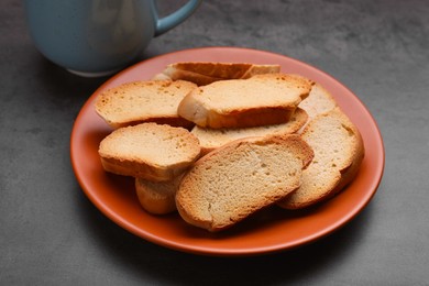 Plate of hard chuck crackers on grey table