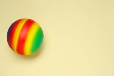 Photo of New bright kids' ball on beige background, top view. Space for text