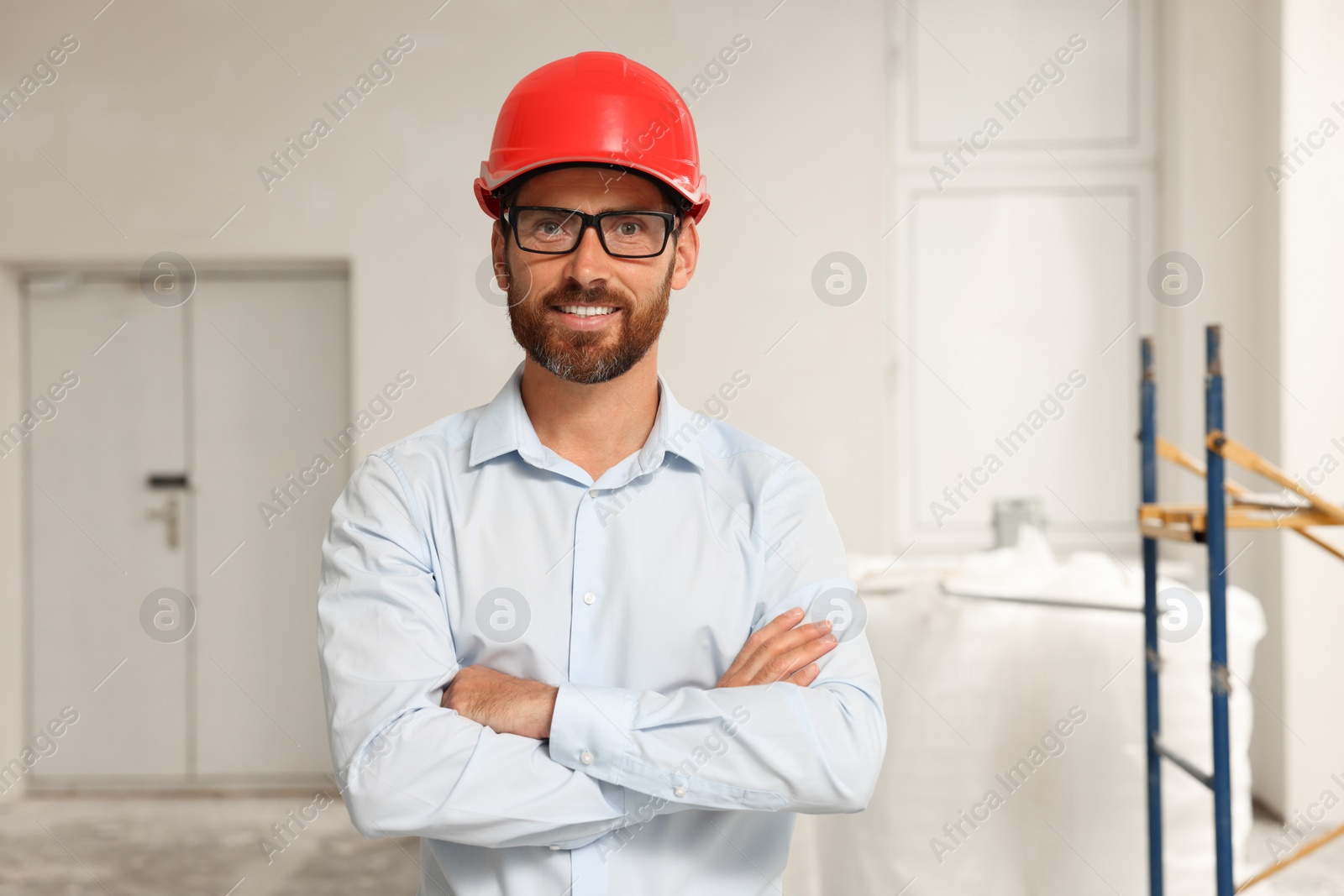 Photo of Portrait of professional engineer in hard hat indoors