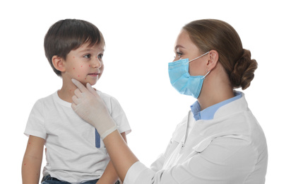Doctor examining little boy with chickenpox on white background. Varicella zoster virus