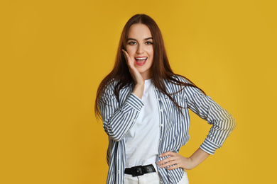 Photo of Portrait of emotional woman on yellow background