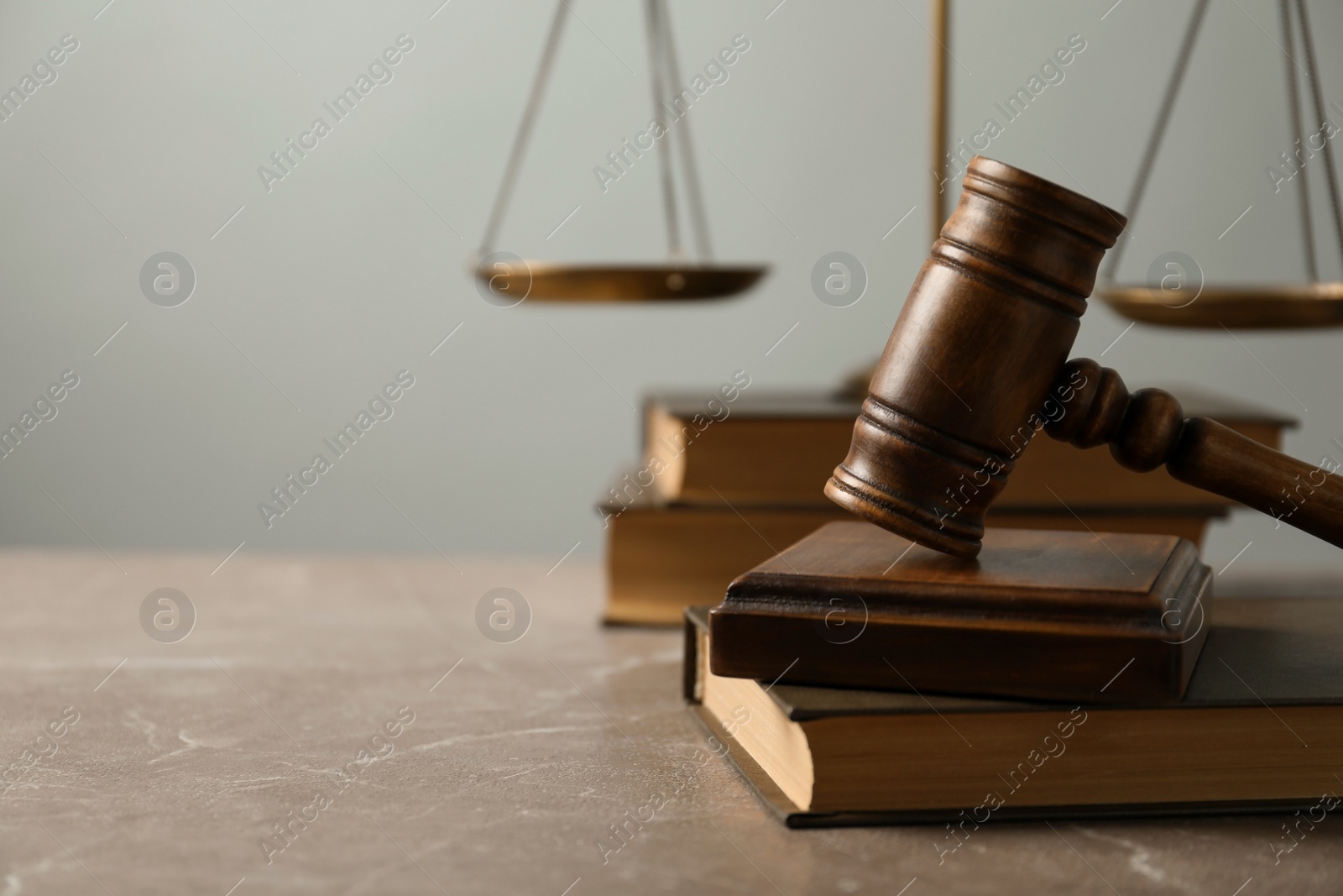Photo of Wooden gavel with scales of justice and books on table. Law concept