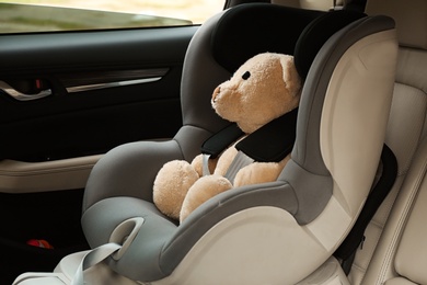 Photo of Safety seat for baby with cute toy bear