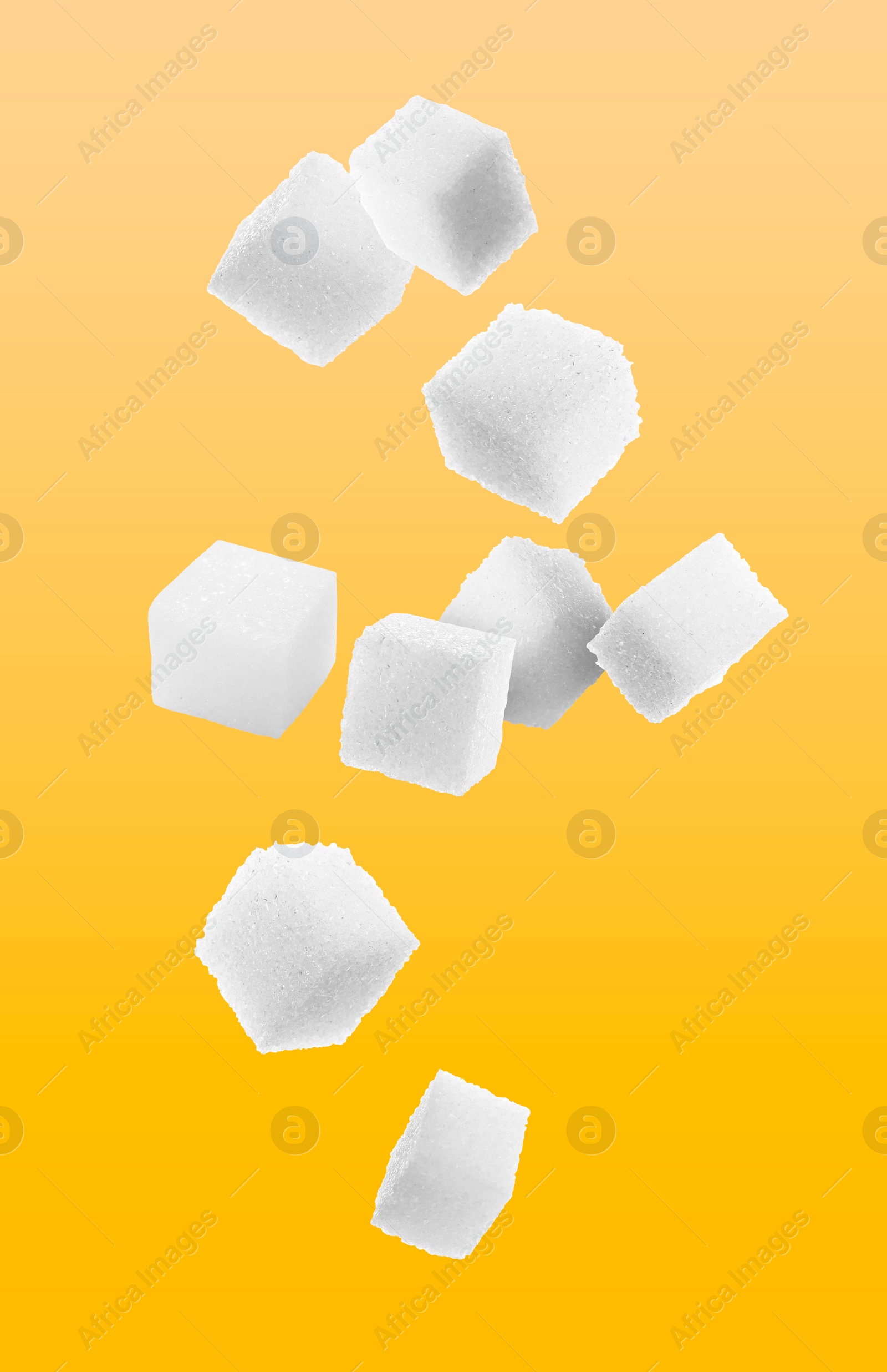 Image of Refined sugar cubes in air on orange background