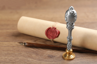 Photo of Notary's public pen and document with wax stamp on wooden table, closeup