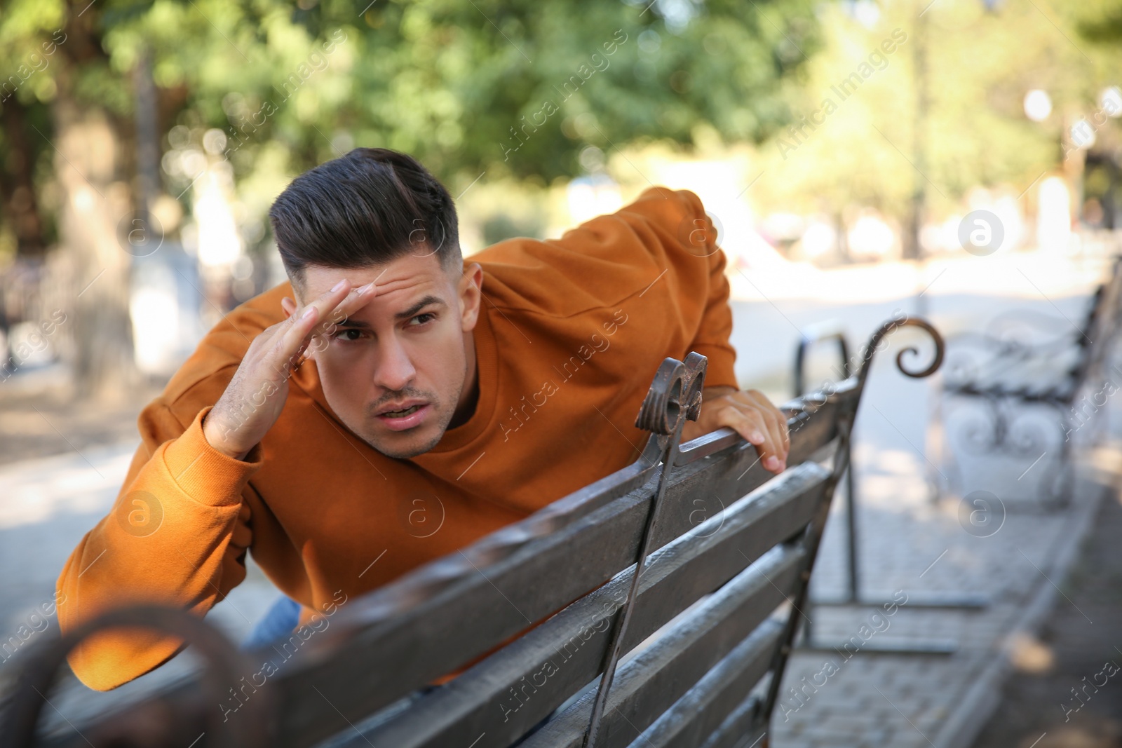 Photo of Jealous man spying on ex girlfriend in park