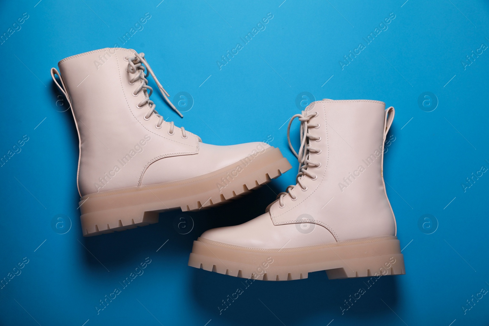 Photo of Pair of stylish leather shoes on light blue background, flat lay