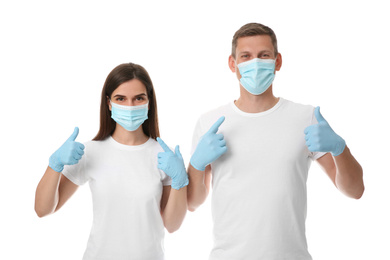 Photo of Volunteers in masks and gloves on white background. Protective measures during coronavirus quarantine